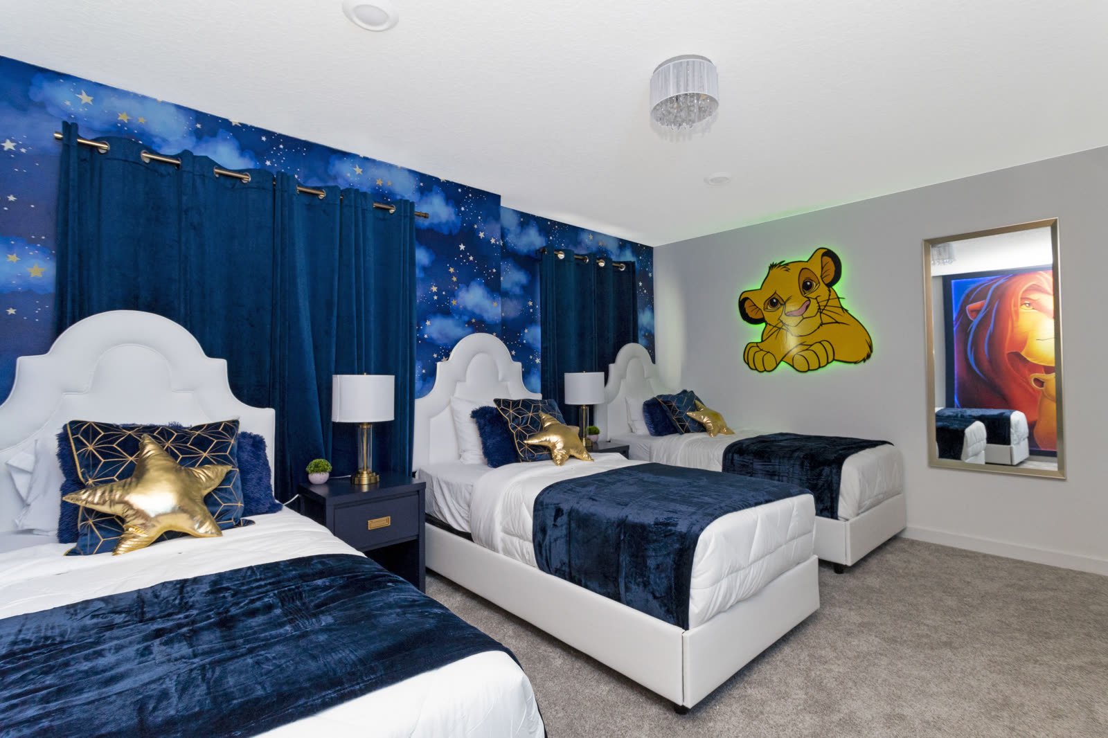 Lion King themed kids' bedroom with three single beds at The Disney Villa